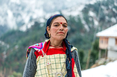 Portrait of woman standing in snow