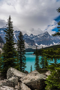 Scenic view of lake by mountains against sky