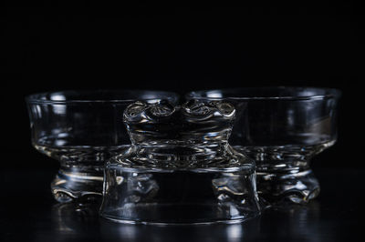 Close-up of glass bowls against black background