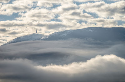 Scenic view of mountains against cloudy sky