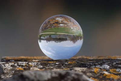 Close-up of glass against sky