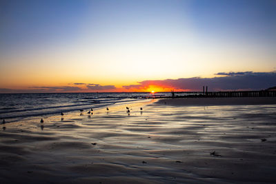 Scenic view of beach against sky during sunset