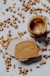 High angle view of bread and peanut butter on table