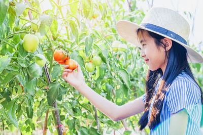 Side view of a girl holding fruit salad