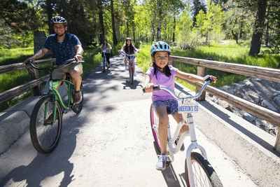 Rear view of girl riding bicycle