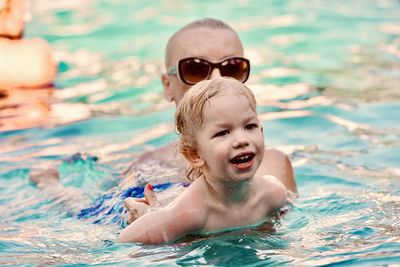 Portrait of boy swimming in pool