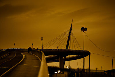 Silhouette bridge against sky during sunset