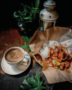 High angle view of cup and coffee on table