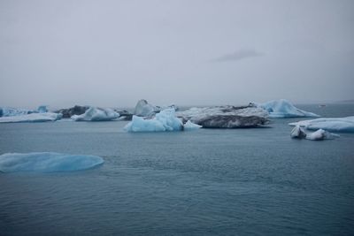 Scenic view of frozen iceberg against sky