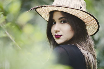 Portrait of young woman in hat