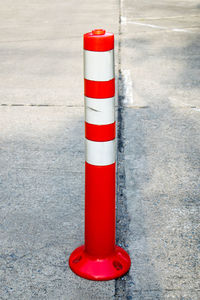 Close-up of red umbrella on road