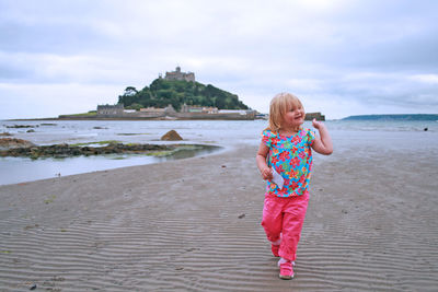 Full length of girl standing on beach