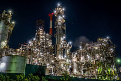 Low angle view of illuminated buildings against sky at night