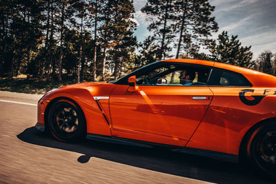 View of red car on road