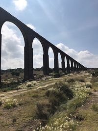 Arch bridge against sky