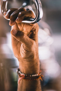 Cropped hand of man with chain