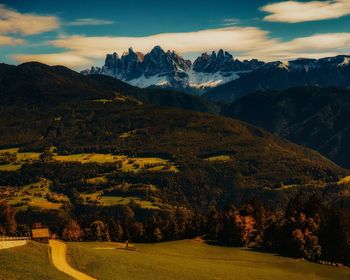 Scenic view of field and mountains against sky