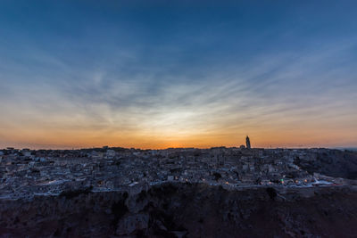 Buildings in city during sunset