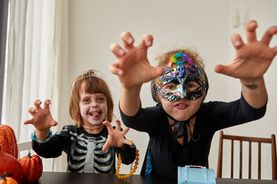 Portrait of siblings playing with toys on table