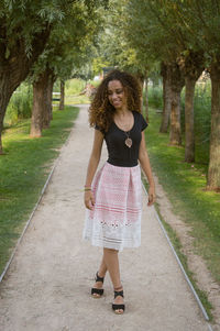 Full length of young woman standing in park