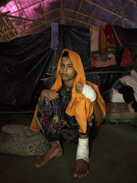 Portrait of young woman sitting at home