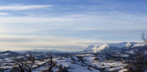 Scenic view of snow covered mountains against sky