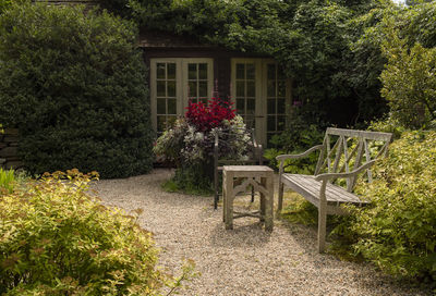 View of wooden house and plants in garden