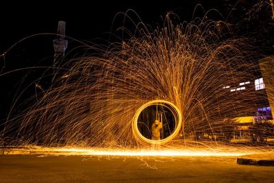 Man playing with fireworks at night