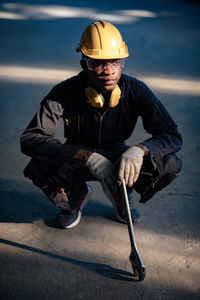 Man wearing hat sitting outdoors