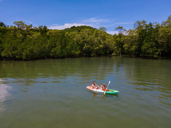 Rear view of man kayaking in lake