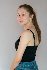 Portrait of a smiling young woman against white background