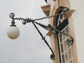 Low angle view of lantern hanging against sky