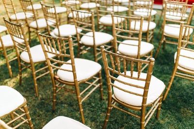 Gold chiavari chairs at outdoor garden wedding