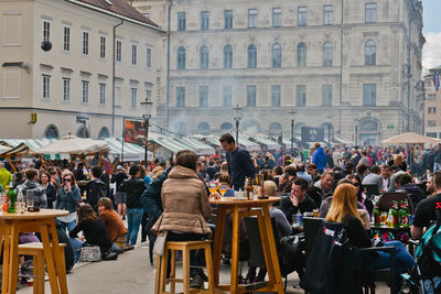 Crowd during food festival on city street against building