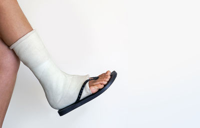 Low section of woman against white background