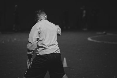 Rear view of man walking on street
