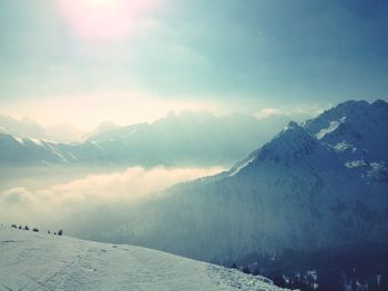 Scenic view of snow covered mountains against sky