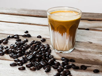 Close-up of coffee beans in glass on table