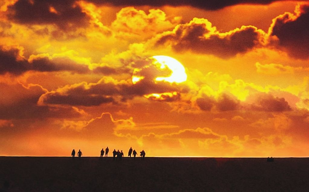 sky, cloud, sunset, afterglow, silhouette, group of people, nature, beauty in nature, horizon, environment, orange color, dawn, land, evening, scenics - nature, sun, dramatic sky, outdoors, landscape, sunlight, medium group of people, animal