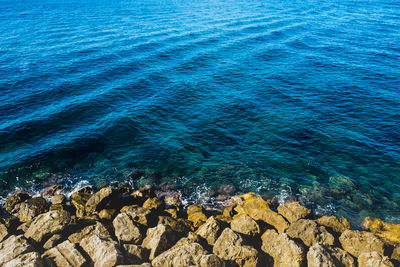 High angle view of rocks at sea shore