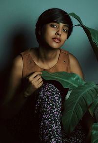 Portrait of young woman sitting outdoors