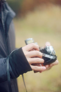 Midsection of person photographing with camera