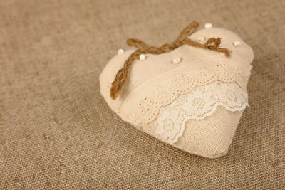 High angle view of heart shape on burlap