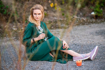 Portrait of young woman sitting outdoors