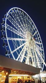 Low angle view of illuminated ferris wheel