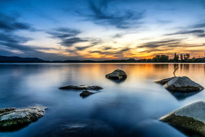 Scenic view of lake against sky during sunset