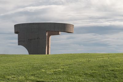 Built structure on field against sky