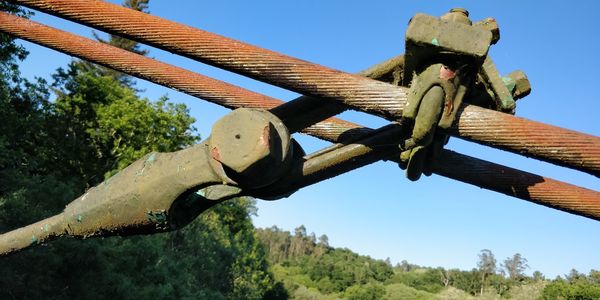 Low angle view of metallic structure against blue sky