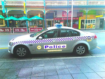 Side view of cars parked on road