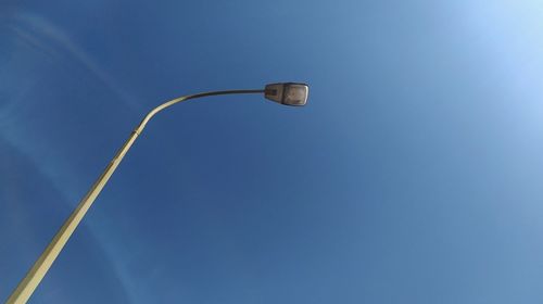 Low angle view of street light against blue sky